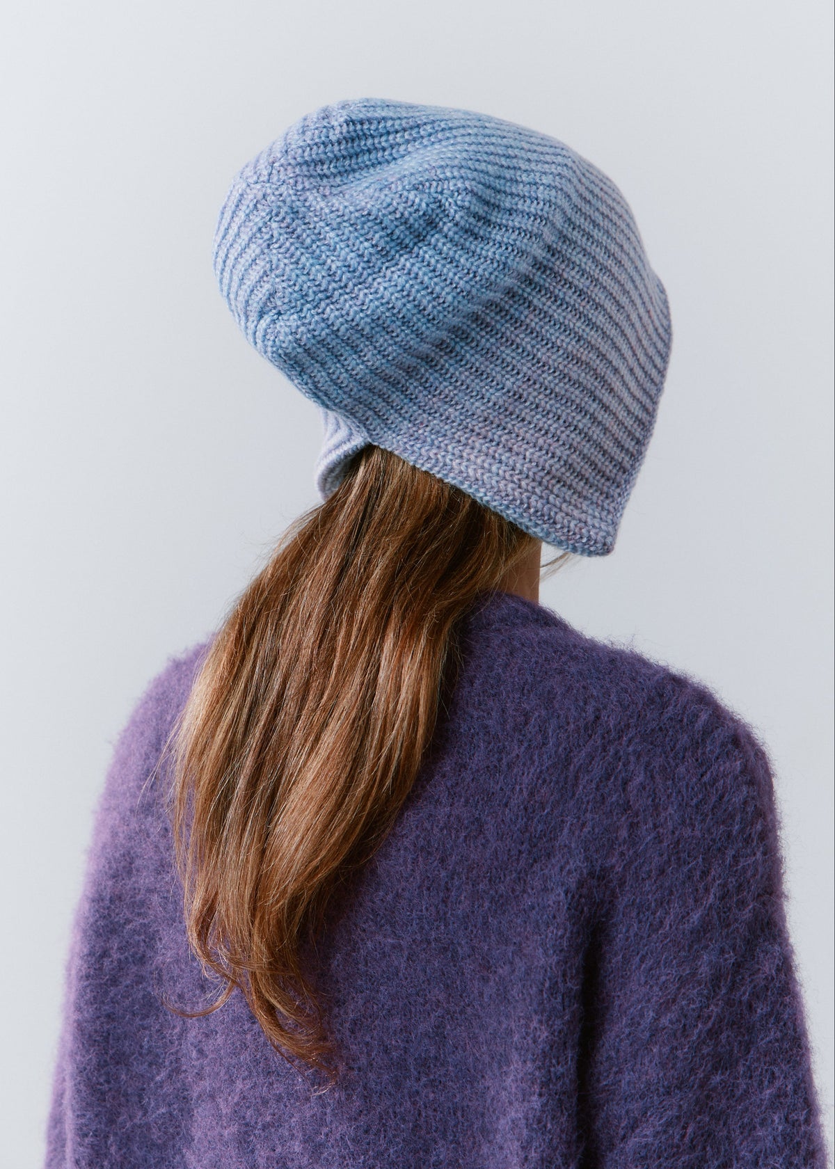 BRIKOLY Lisse Pink reversible knit beanie in pale blue and lilac tones, shown from the back to reveal the knit crown.