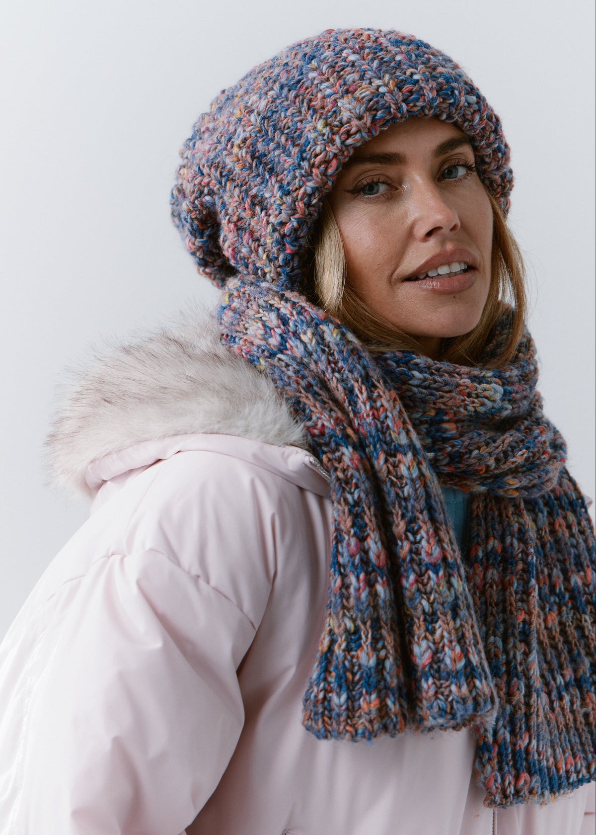 Close-up side view of the BRIKOLY Pink Blue scarf showing blue and pink flecks in the ribbed knit.
