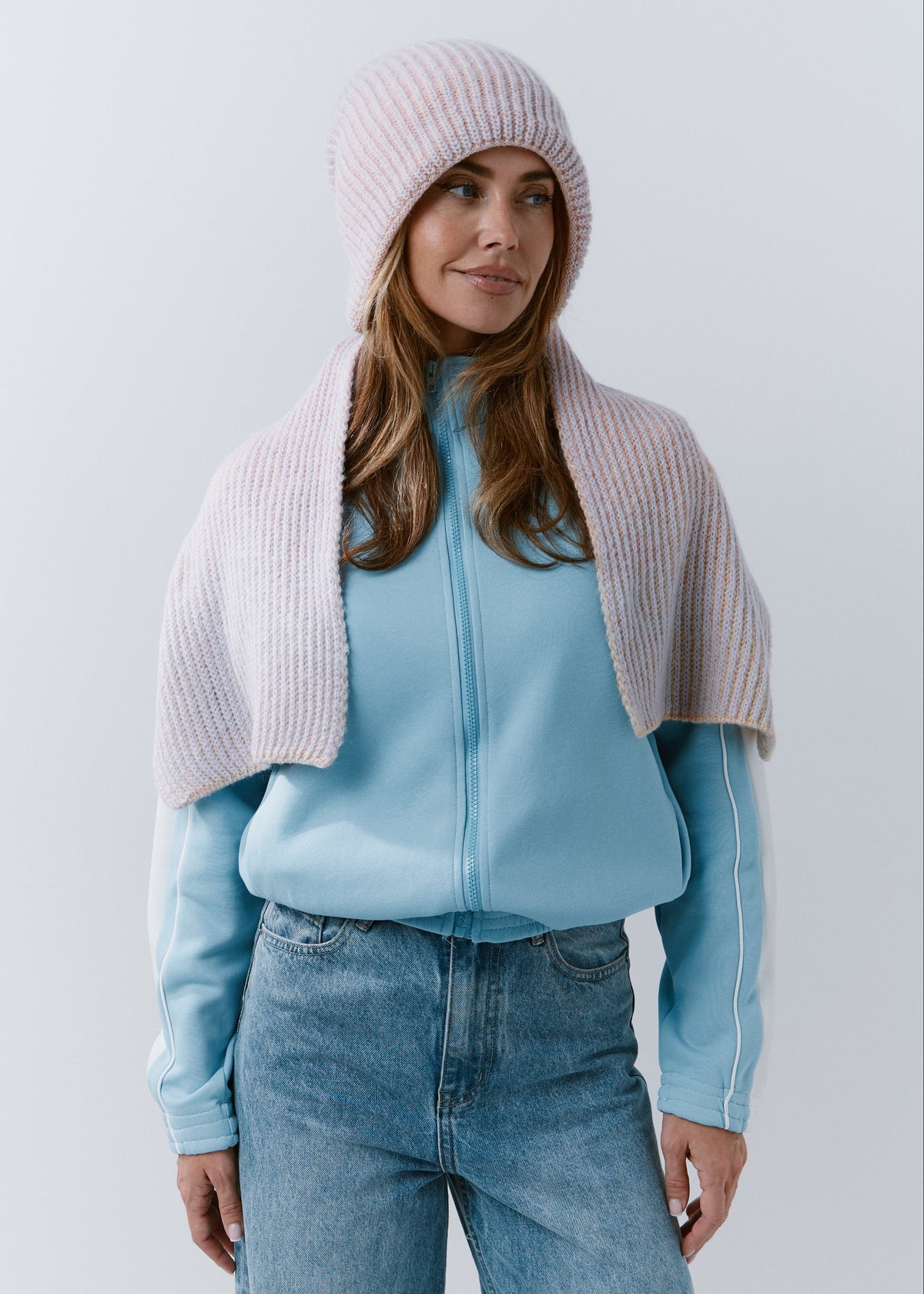 BRIKOLY Lisse Unicorn pale multicolor ribbed knit scarf shown in a front view draped over a blue jacket.