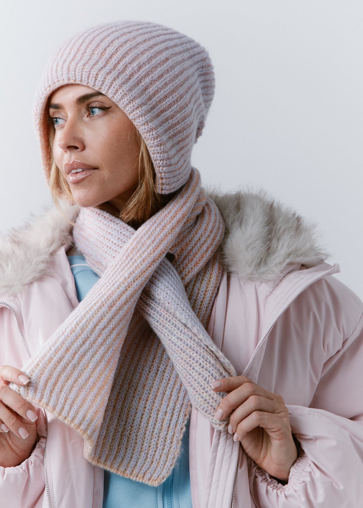 BRIKOLY Lisse Unicorn pale multicolor ribbed knit scarf held by a model to show the ribbed knit and crossed ends.