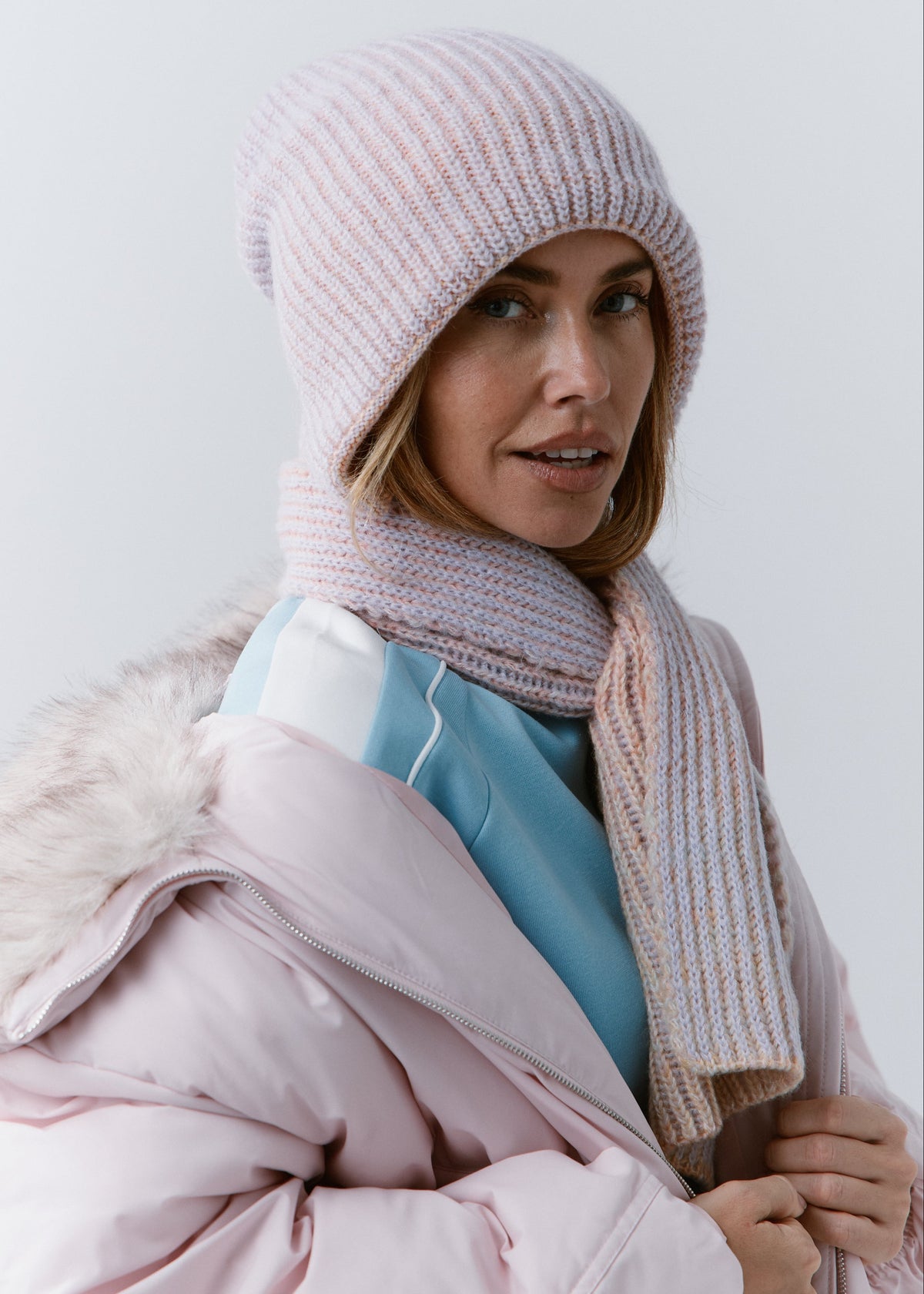 BRIKOLY Lisse Unicorn pale multicolor ribbed knit scarf worn by a model holding the front end.