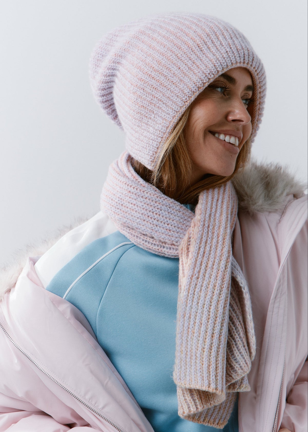 BRIKOLY Lisse Unicorn pale multicolor ribbed knit scarf shown in profile on a smiling model.
