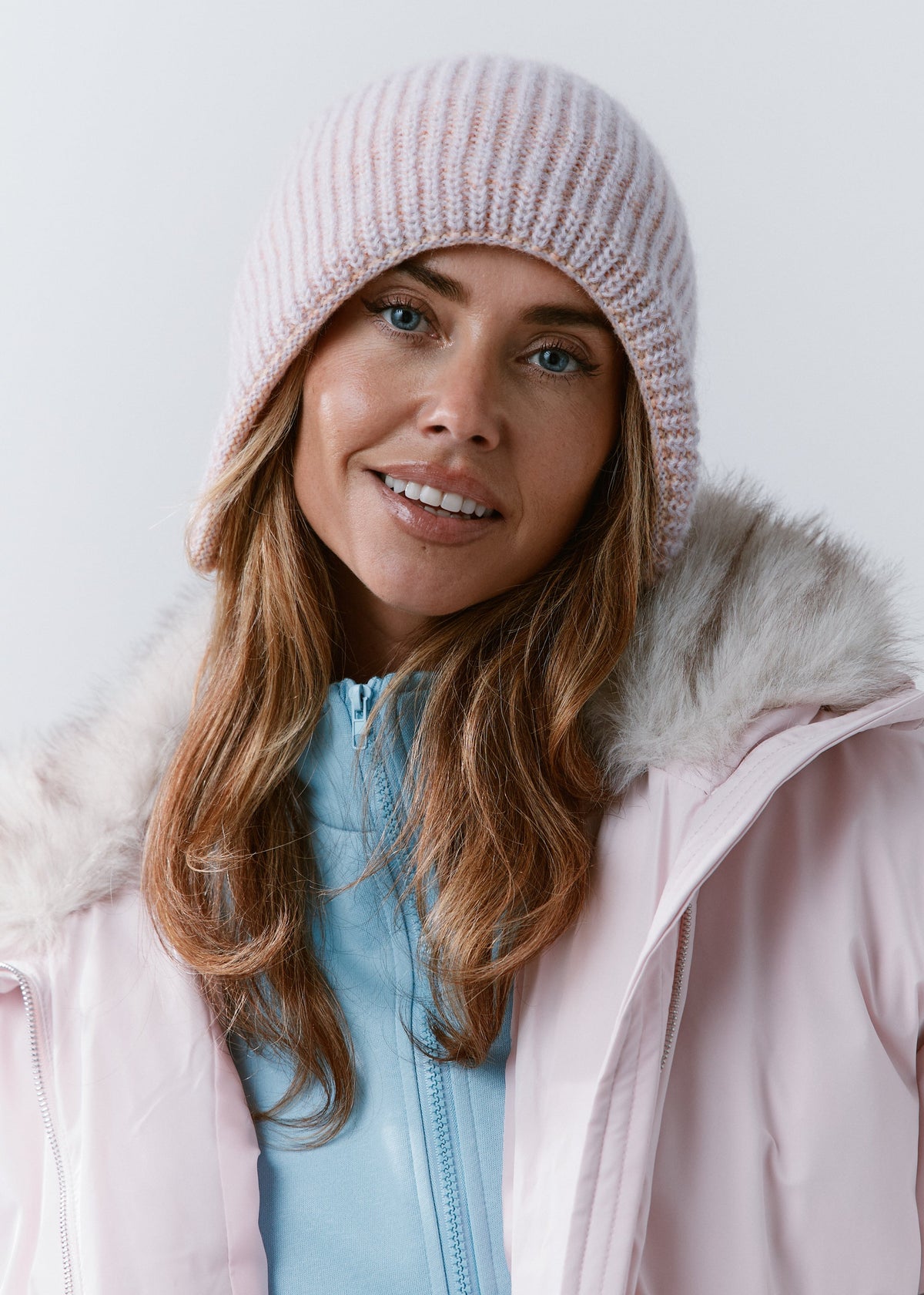 BRIKOLY Lisse Unicorn reversible ribbed knit beanie worn by a smiling model in a front view.