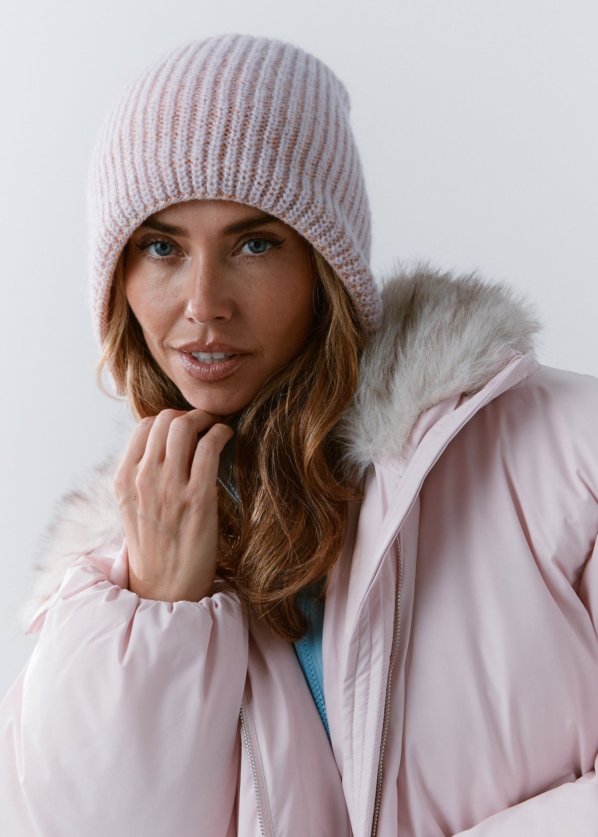 BRIKOLY Lisse Unicorn reversible ribbed knit beanie shown on a model holding the collar of a pink jacket.
