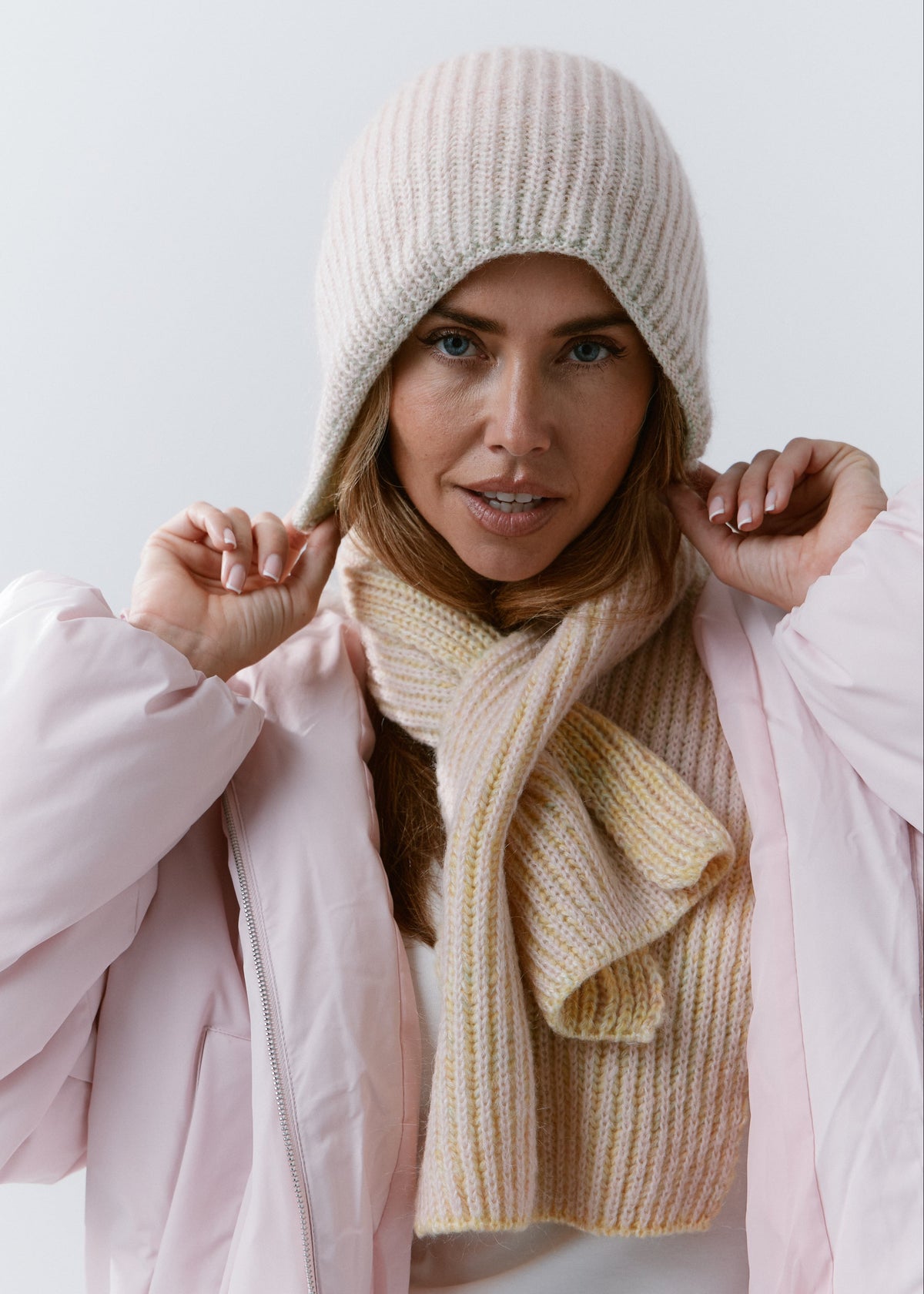 BRIKOLY Lisse Multicolor pale ribbed knit scarf shown in a front view on a model adjusting a matching beanie.