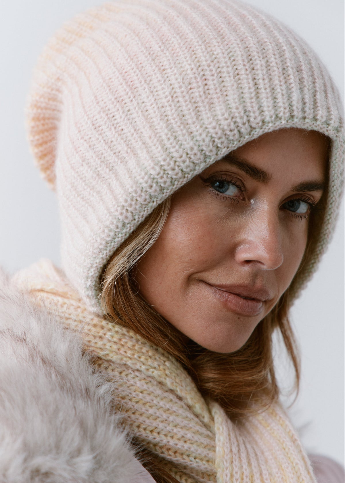 BRIKOLY Lisse Multicolor pale ribbed knit scarf shown close up around a model's neck.