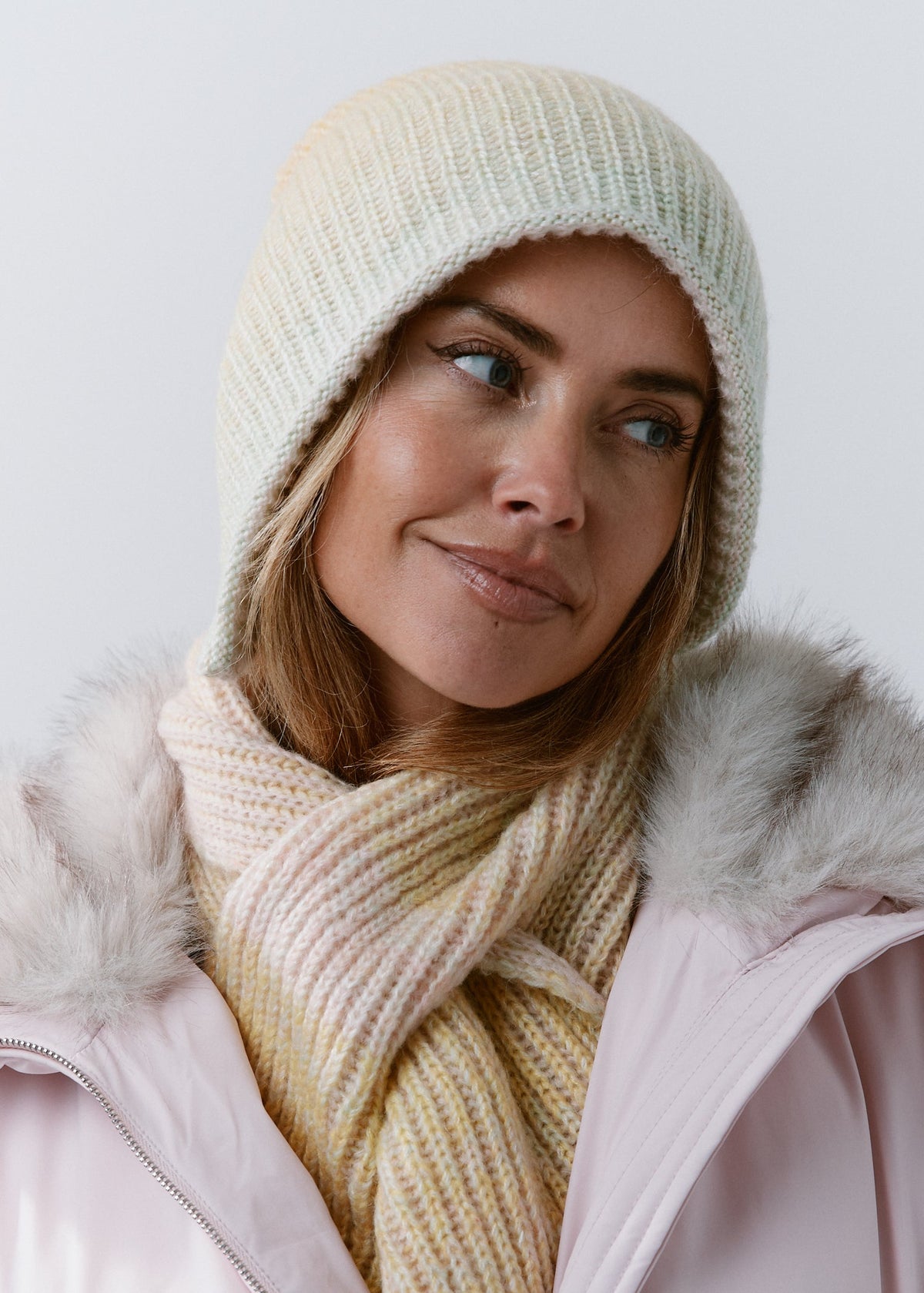 BRIKOLY Lisse Multi reversible ribbed knit beanie worn by a model with a matching pale scarf.