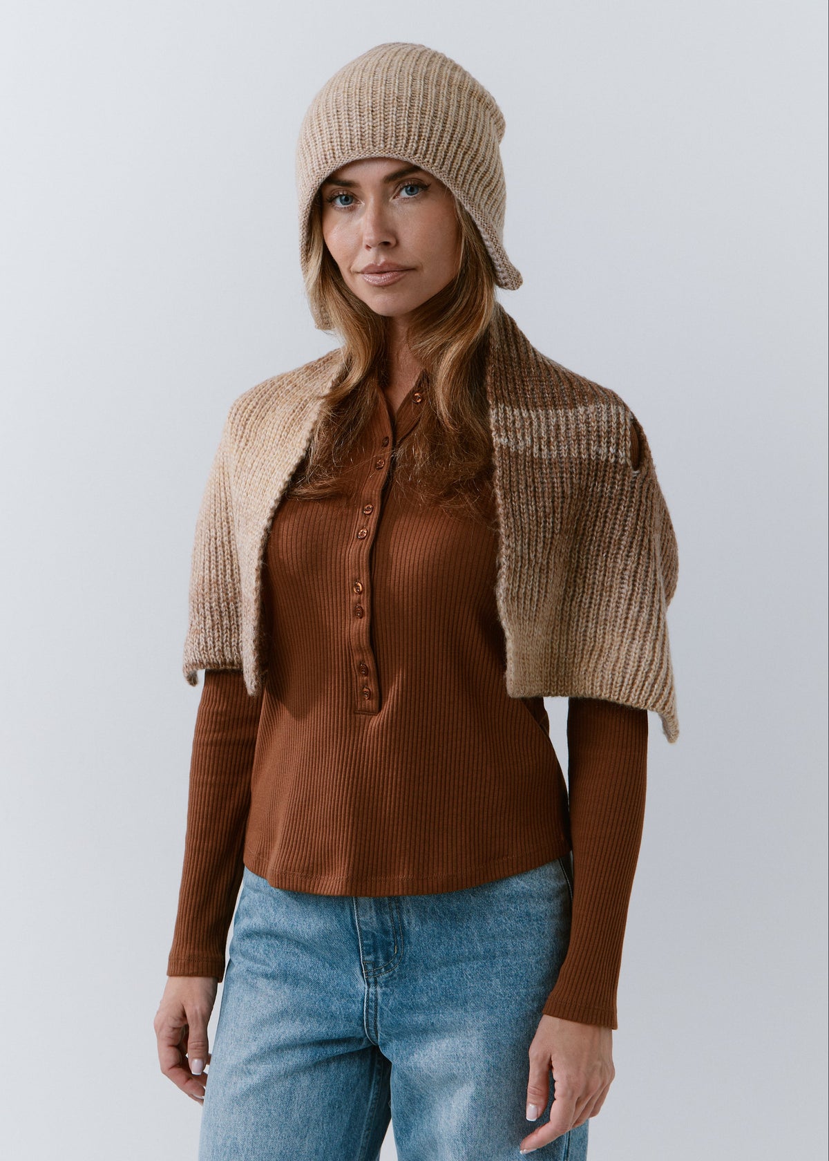 BRIKOLY Lisse Brown ribbed knit scarf shown draped across a model's shoulders in a wider front view.