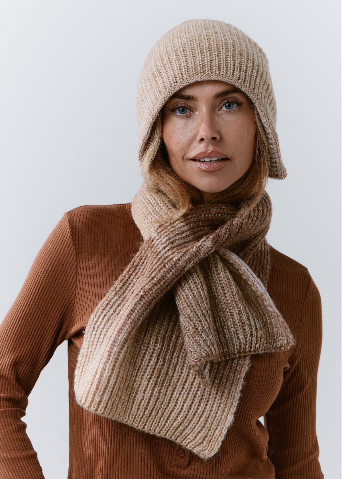 BRIKOLY Lisse Brown ribbed knit scarf secured around a model's neck in a front view.