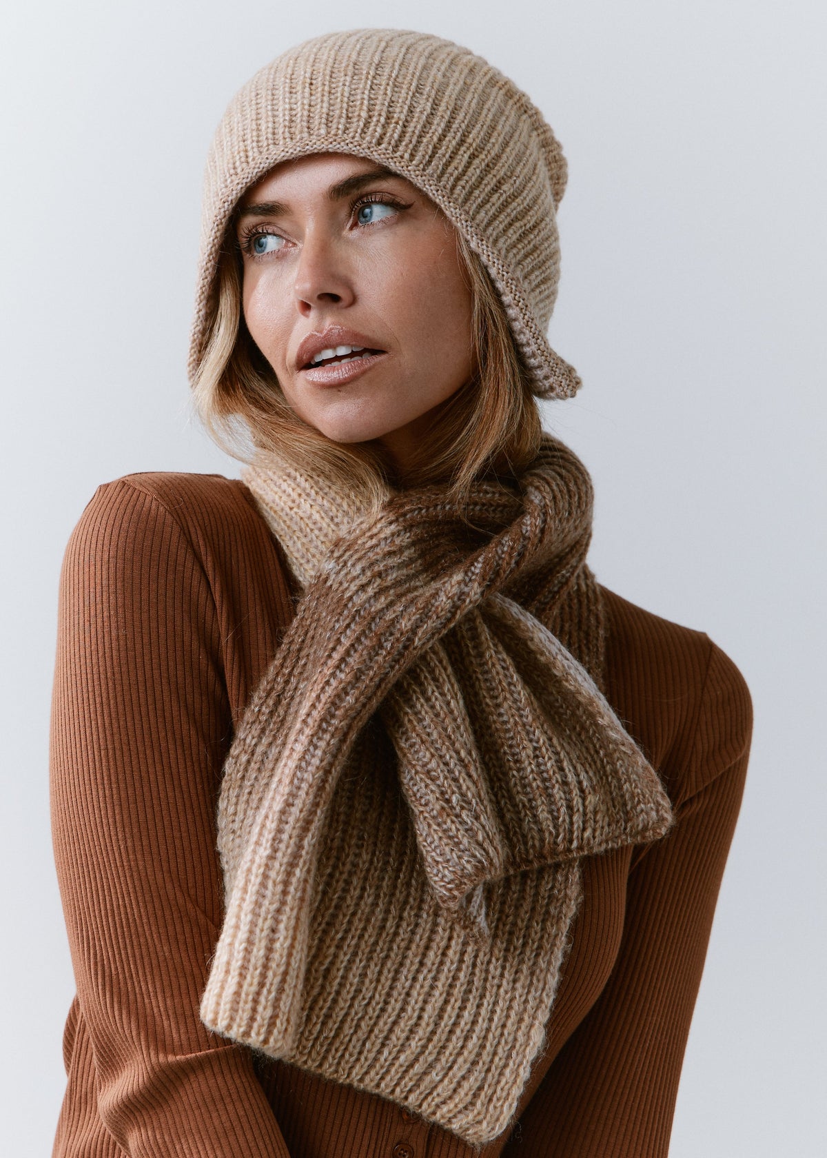 BRIKOLY Lisse Brown reversible ribbed knit beanie worn by a model with a matching scarf secured around her neck.