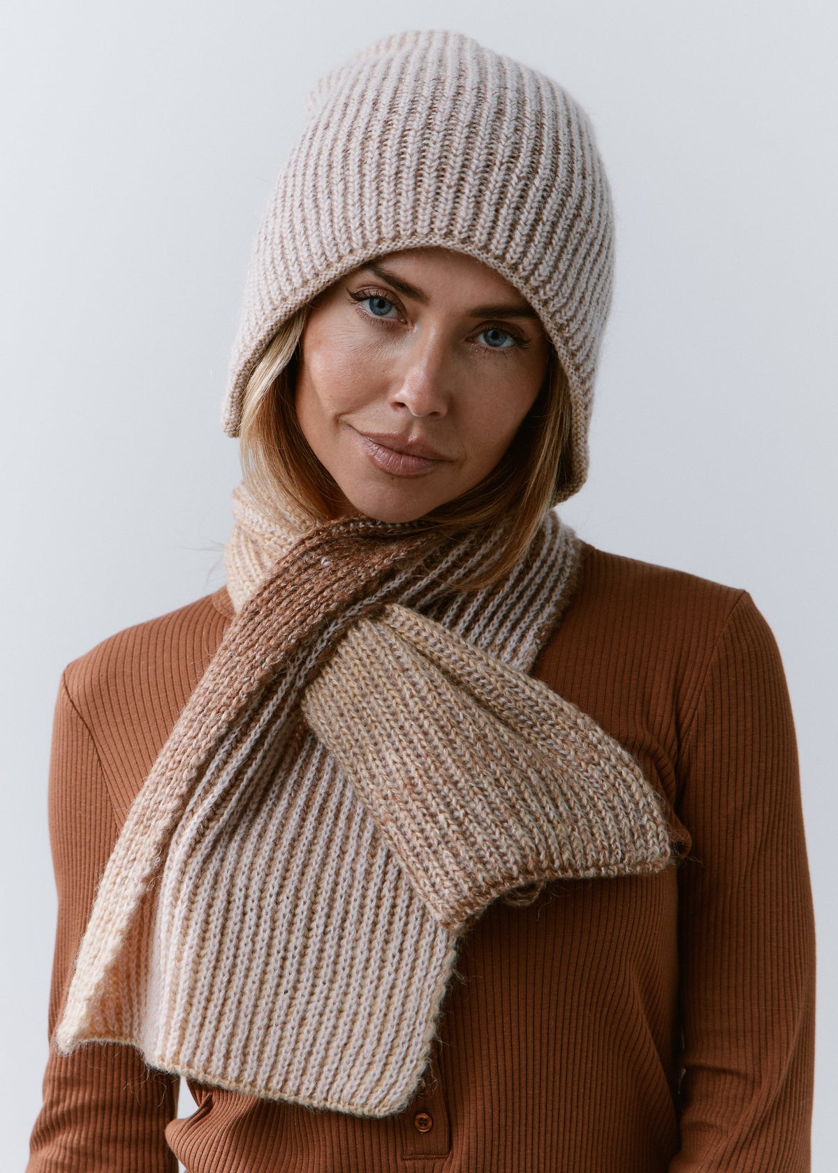 BRIKOLY Lisse Brown ribbed knit scarf secured around a model's neck with the wide ends in front.