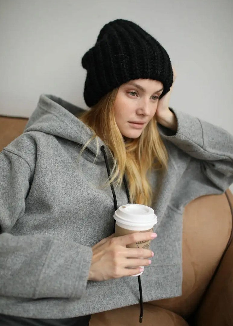 Oversized Black double-layer wool hat: Seated portrait holding a cup