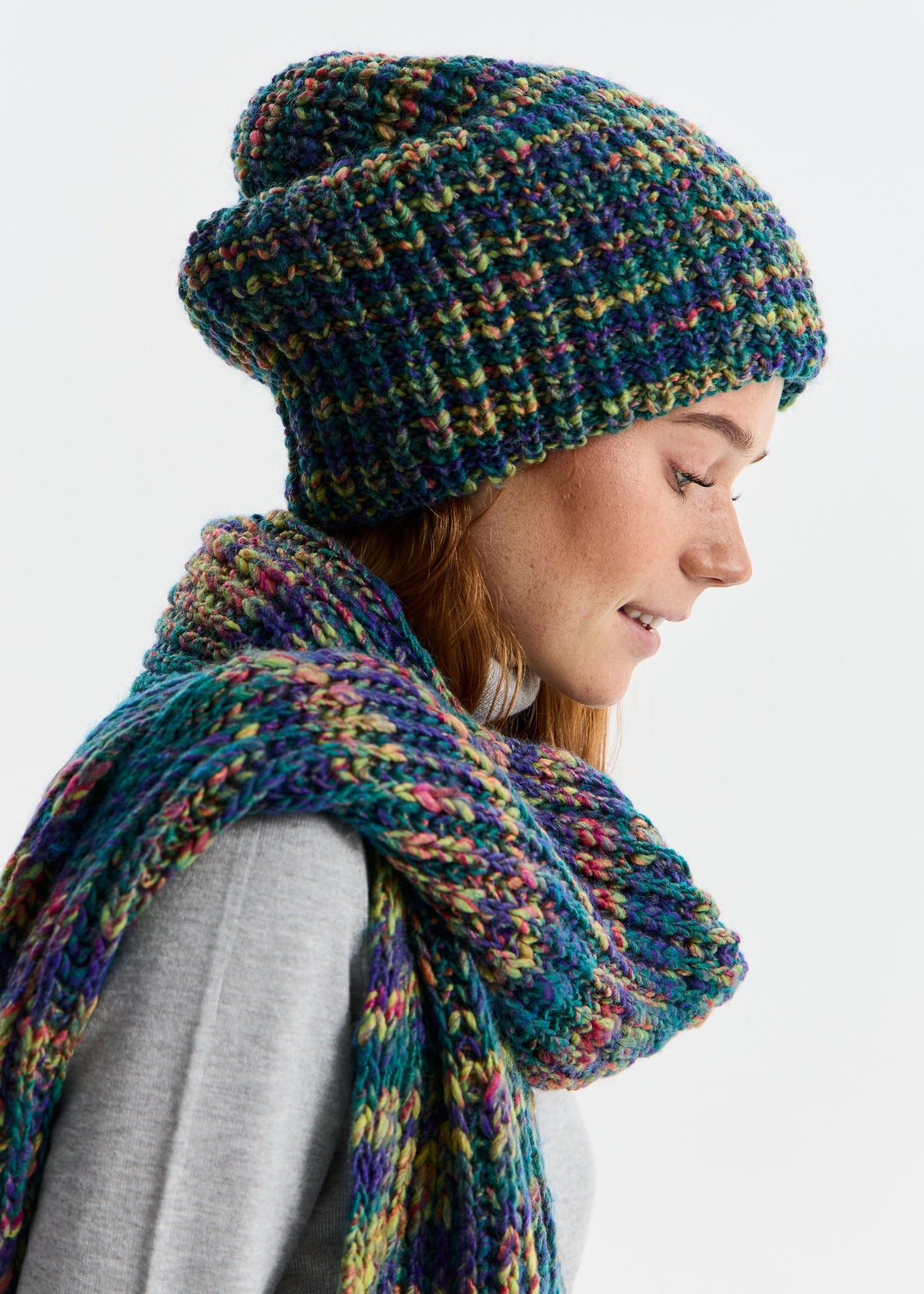 BRIKOLY London Lilac & Navy knit beanie shown on a model looking down with a matching scarf.