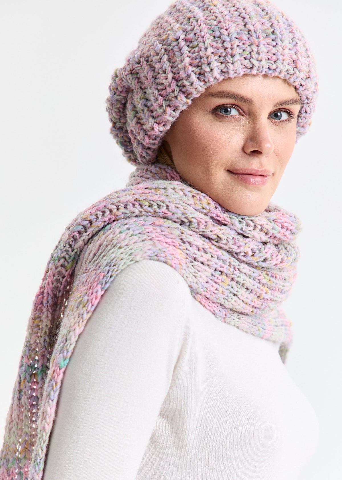 Oversized Unicorn alpaca-wool scarf: Three-quarter portrait in a white top; beanie sold separately