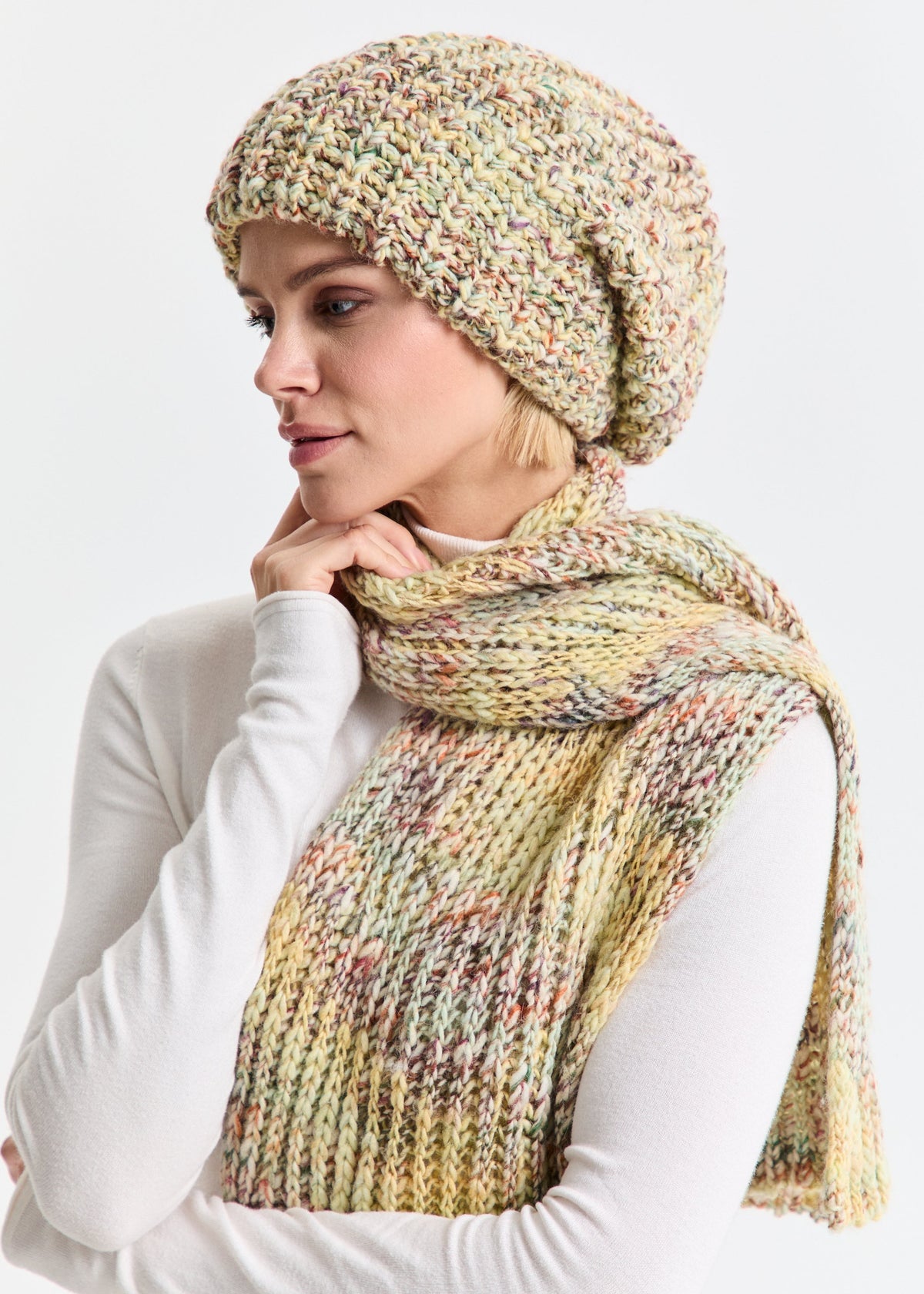 Oversized Yellow & Green alpaca-wool scarf: Three-quarter portrait in a white turtleneck; beanie sold separately