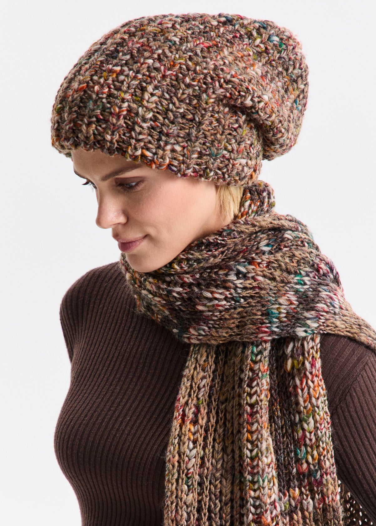 Oversized Multicolor alpaca-wool scarf: Three-quarter portrait in a brown turtleneck; beanie sold separately