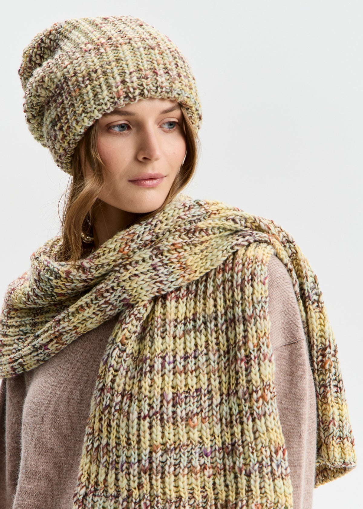 BRIKOLY London Yellow knit beanie worn by a model looking to the side with a matching scarf.