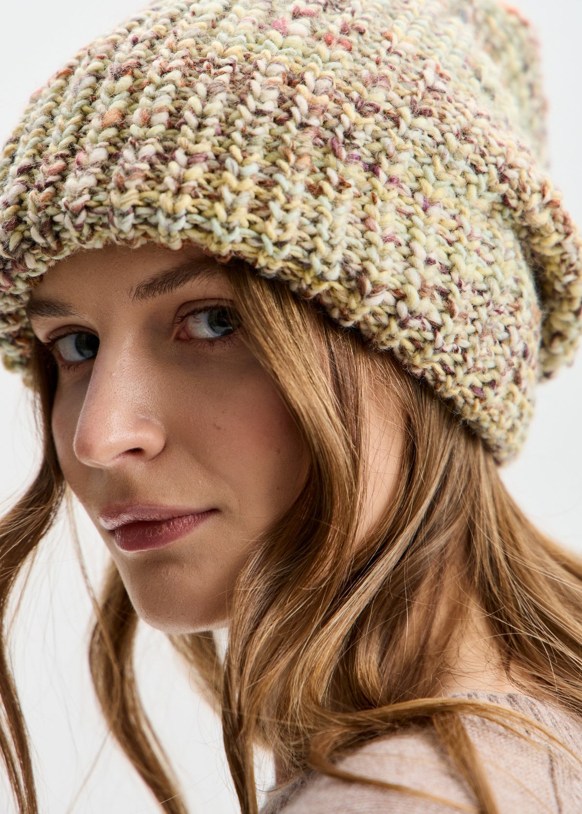 BRIKOLY London Yellow knit beanie shown close up to reveal pale yellow-green multicolor yarn and the ribbed brim.