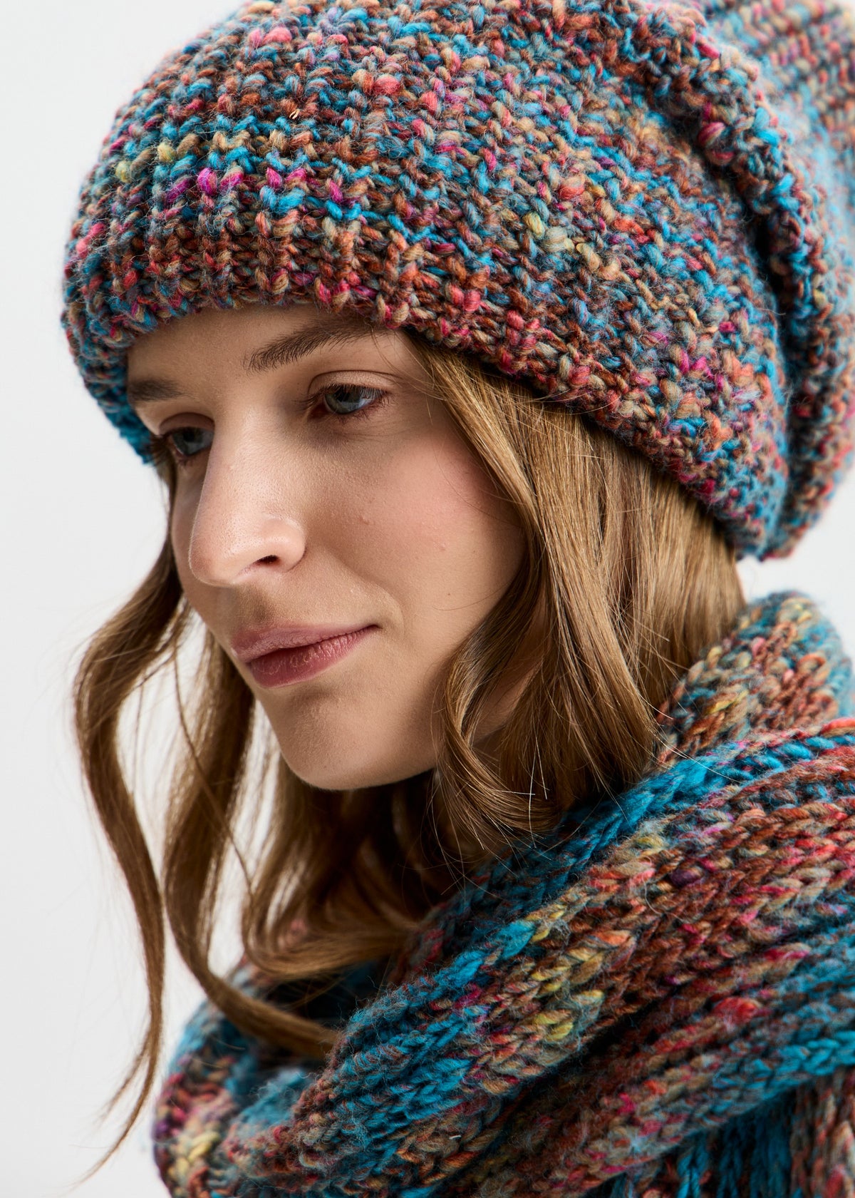 BRIKOLY London Turquoise multicolor knit beanie shown close up with a matching scarf to reveal its multicolor yarn.