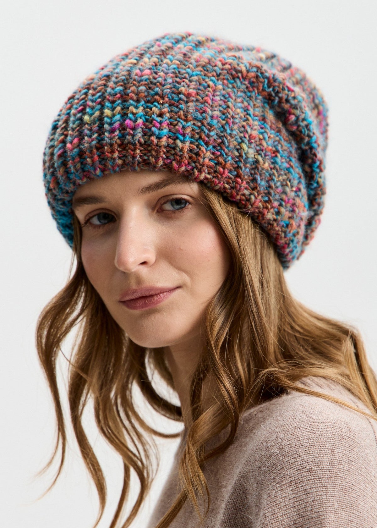 BRIKOLY London Turquoise multicolor knit beanie shown in a close front view on a model.