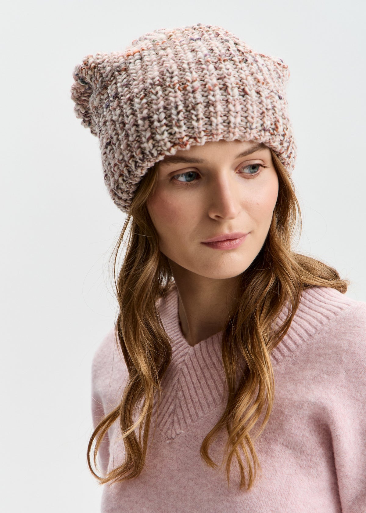 BRIKOLY London Beige multicolor knit beanie worn by a model looking to the side.