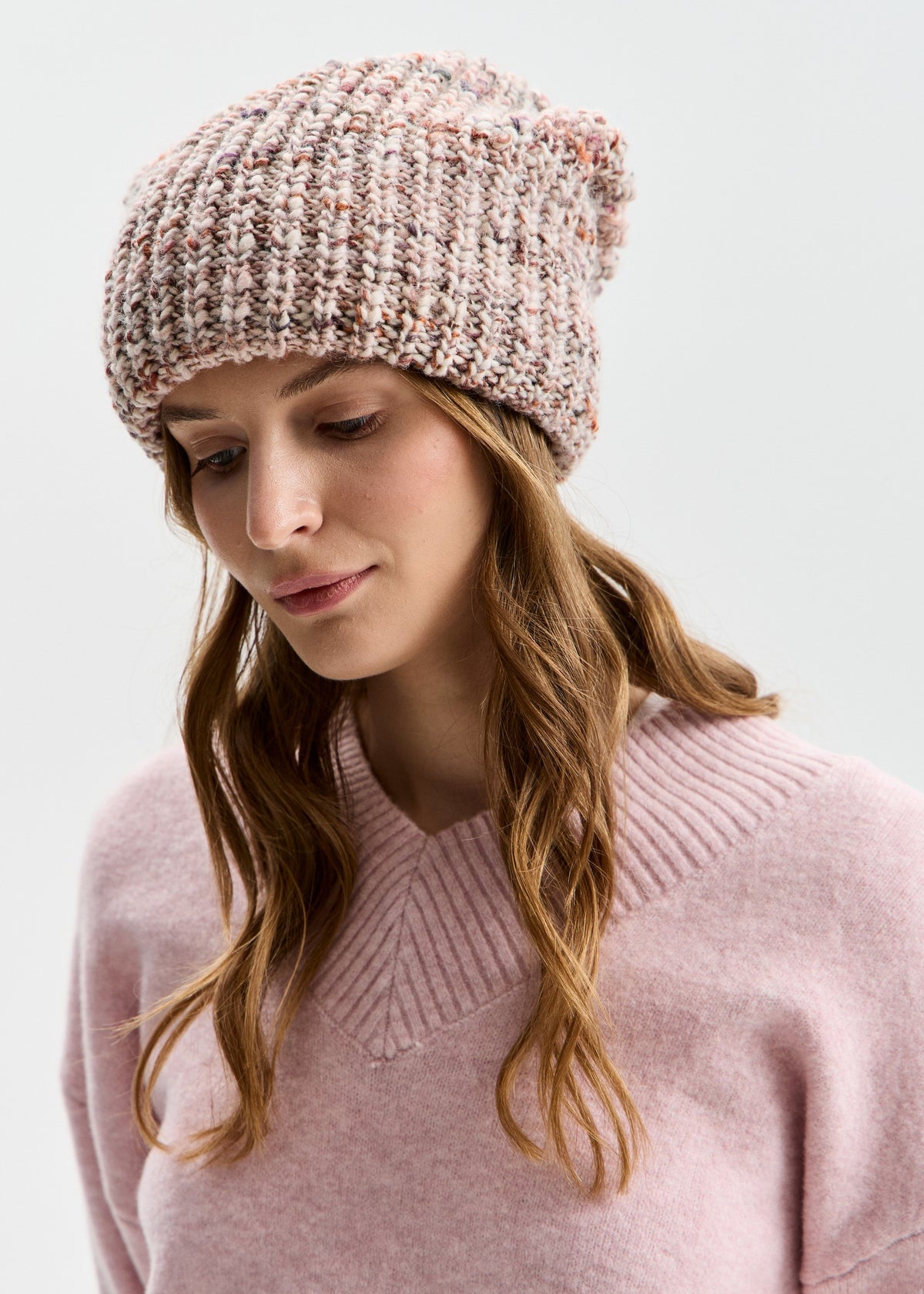 BRIKOLY London Beige multicolor knit beanie shown on a model with head tilted down.