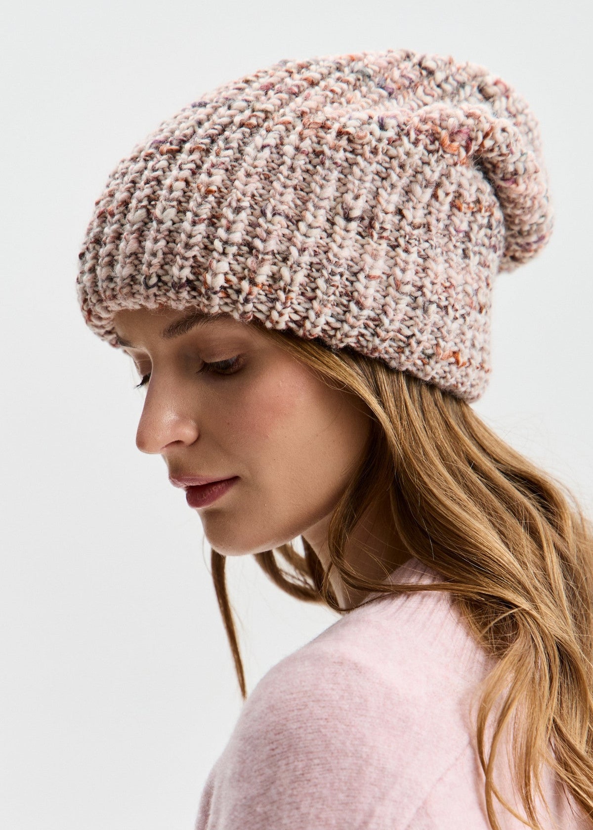 BRIKOLY London Beige multicolor knit beanie shown in profile on a model looking down.