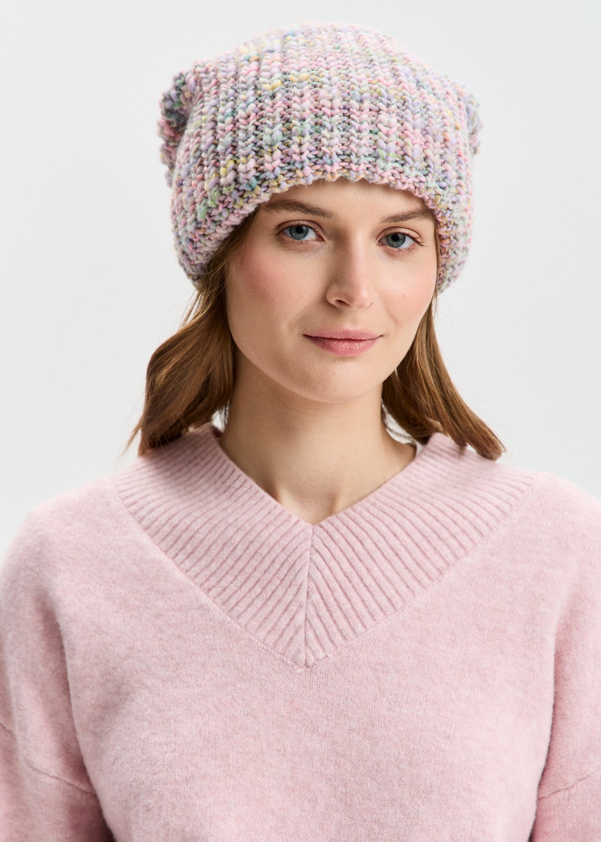 BRIKOLY London Unicorn pastel multicolor knit beanie shown in a front view on a model.