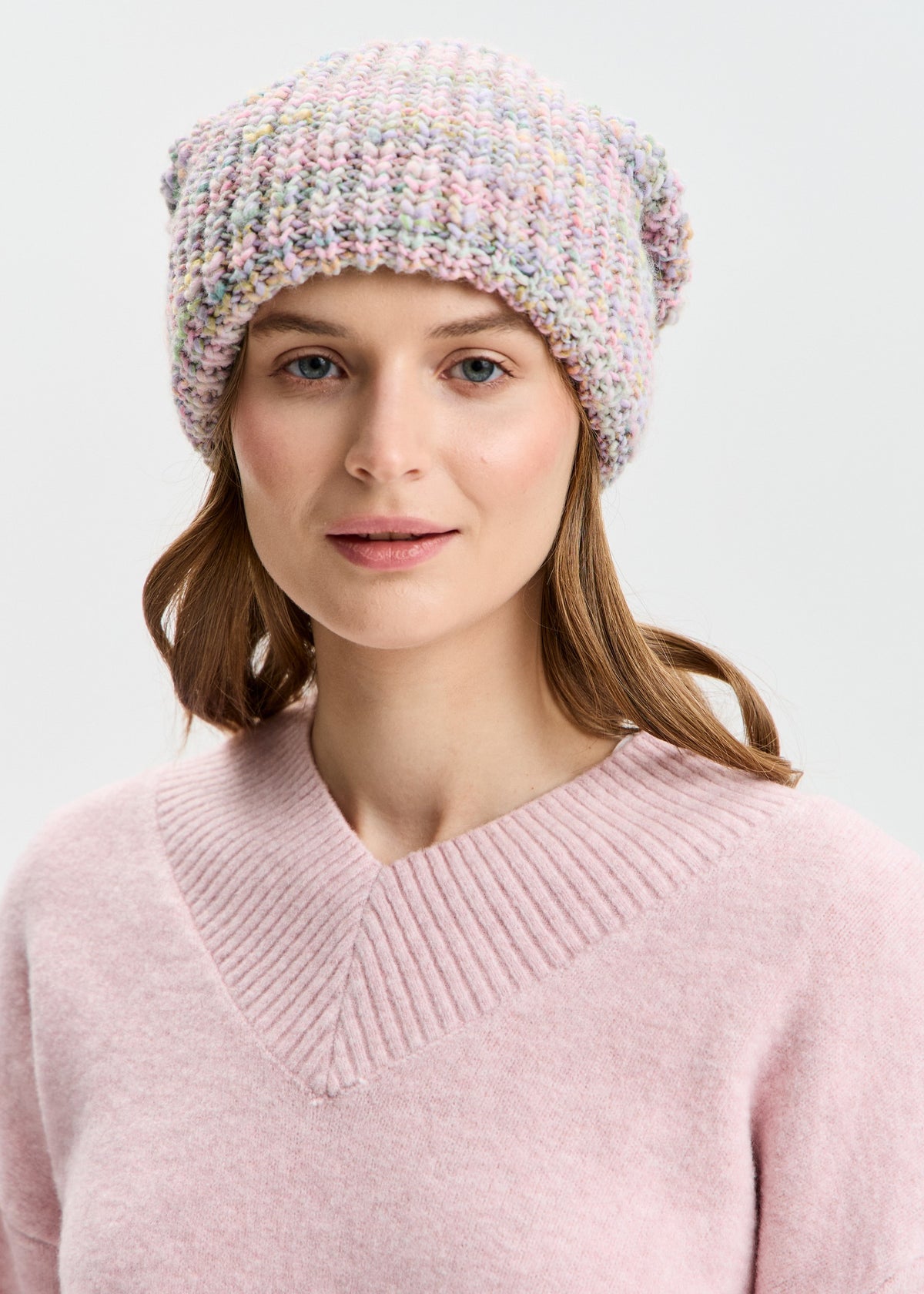 BRIKOLY London Unicorn pastel multicolor knit beanie shown on a model facing the camera.