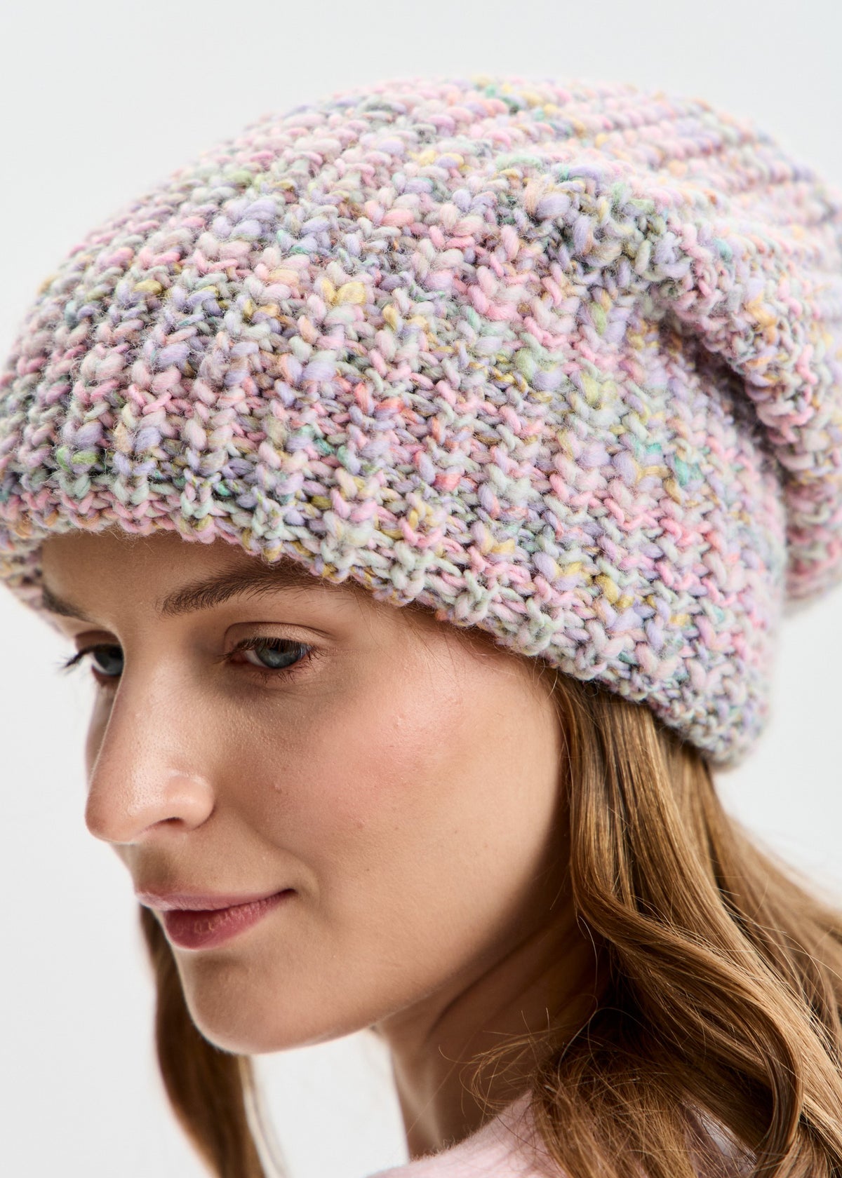 BRIKOLY London Unicorn pastel multicolor knit beanie shown in a close-up view of the pastel knit texture.
