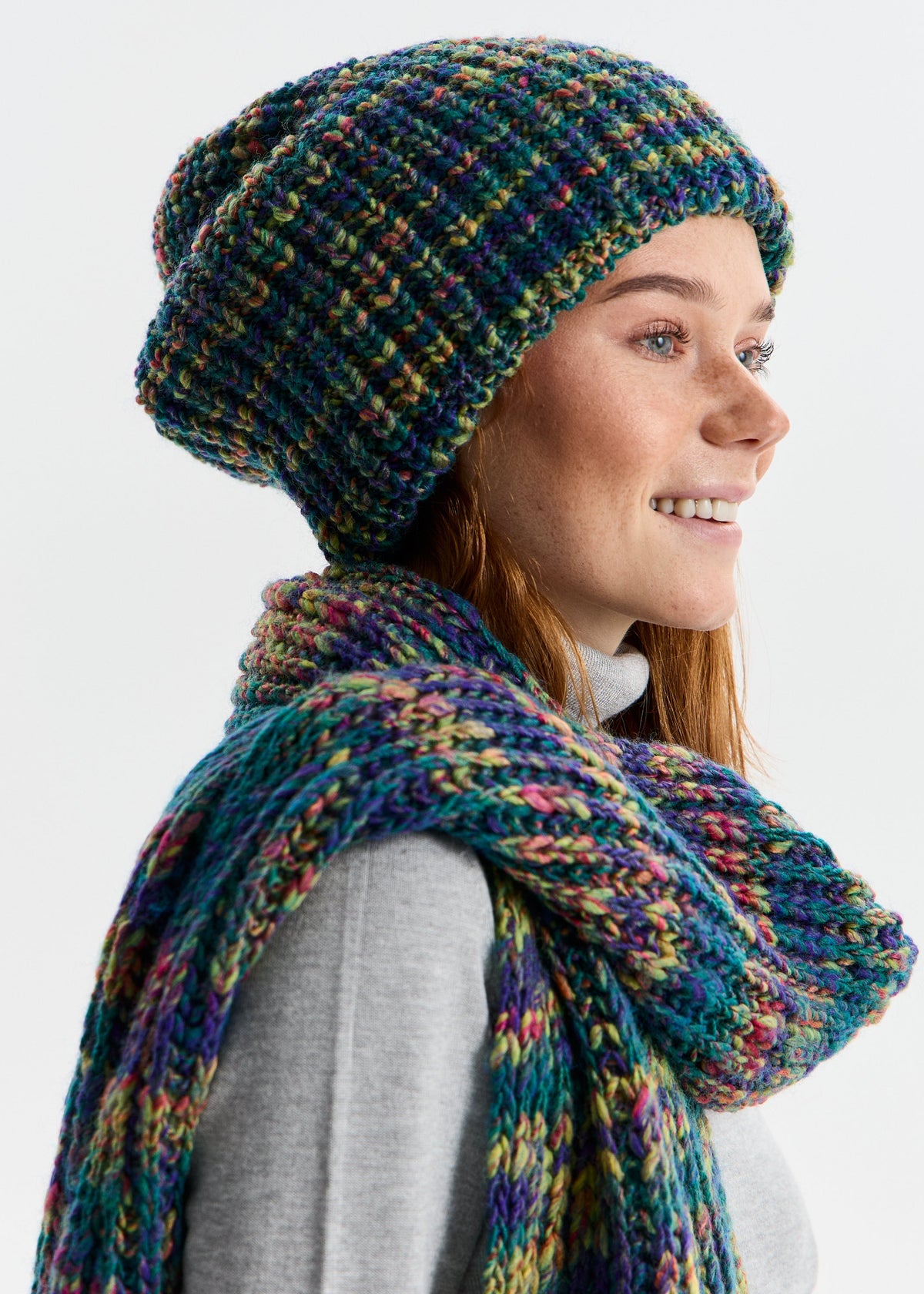 BRIKOLY London Lilac & Navy knit beanie shown on a smiling model with a matching scarf.