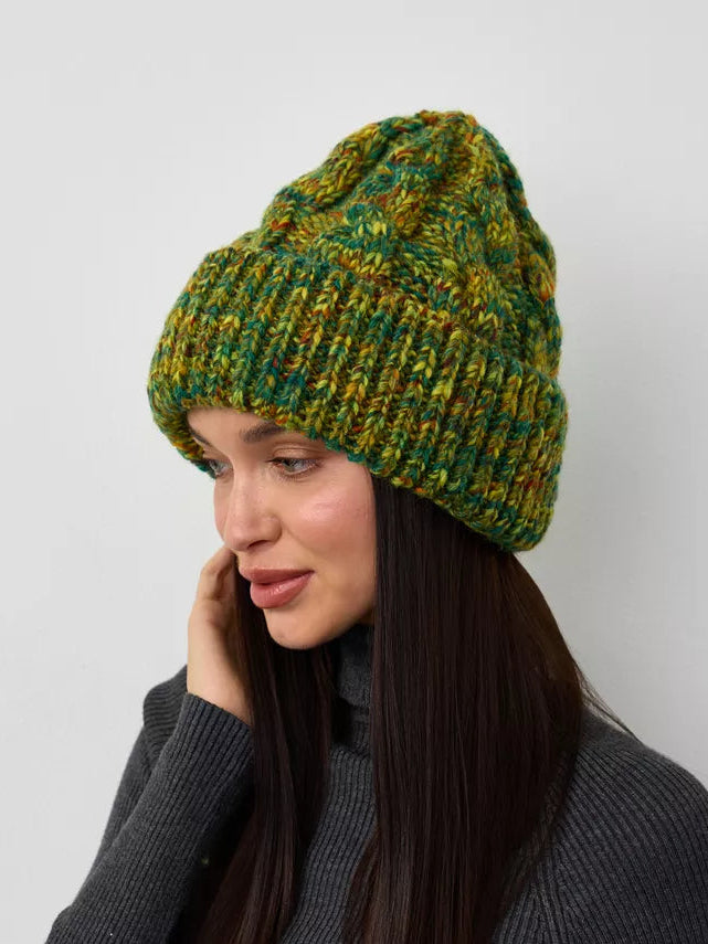 Tokyo Khaki cable knit wool beanie: Three-quarter portrait with a hand beside the face