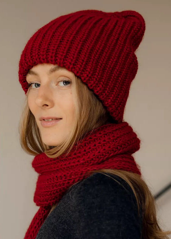 BRIKOLY London Burgundy knit beanie shown in a close three-quarter view with a matching scarf.