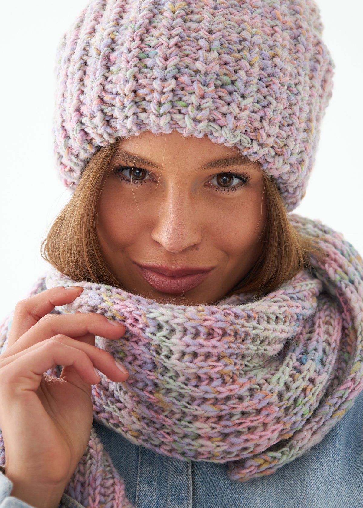 Oversized Unicorn alpaca-wool scarf: Close-up holding the pastel knit near the face; beanie sold separately