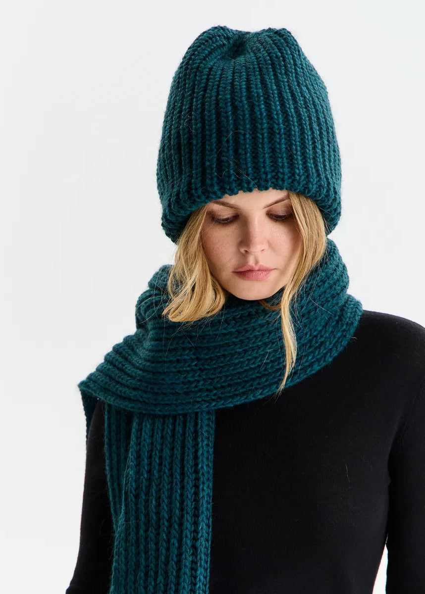 BRIKOLY London Emerald knit beanie shown on a model looking down with a matching scarf.