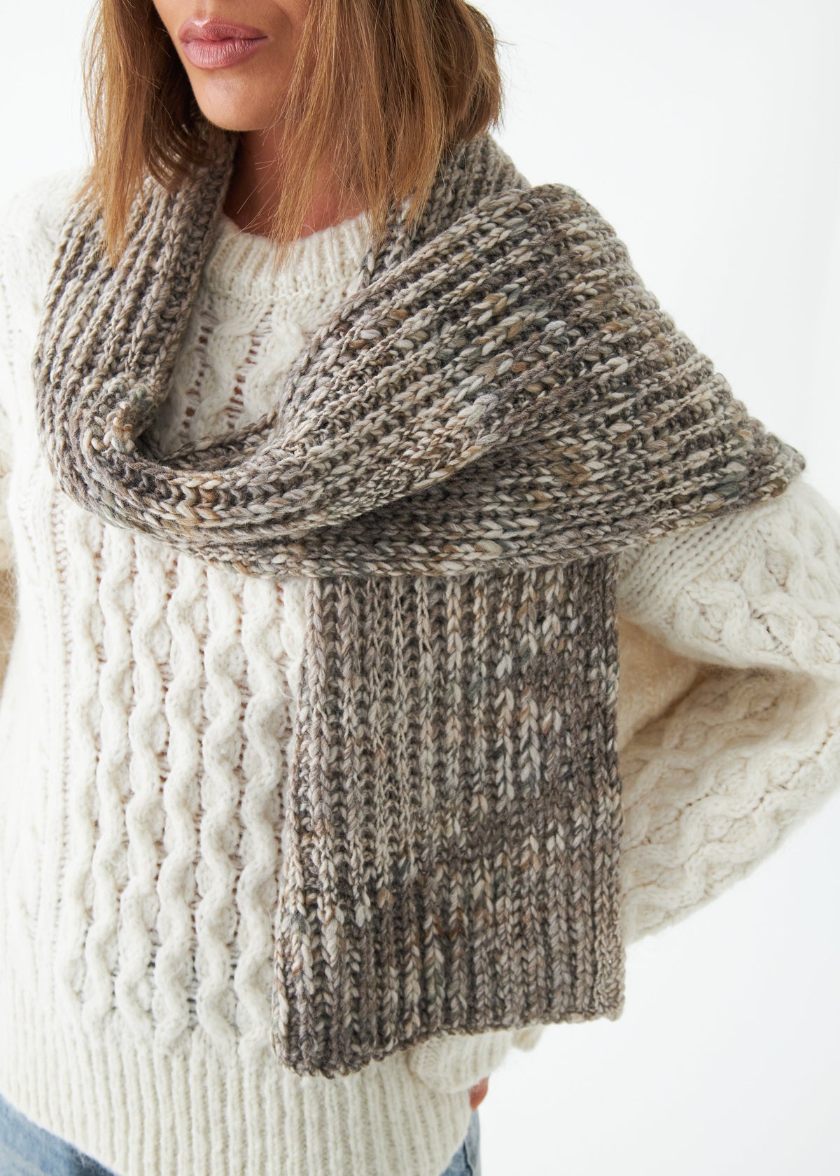 Oversized Gray alpaca-wool scarf: Close-up of the gray knit draped over a sweater; beanie sold separately
