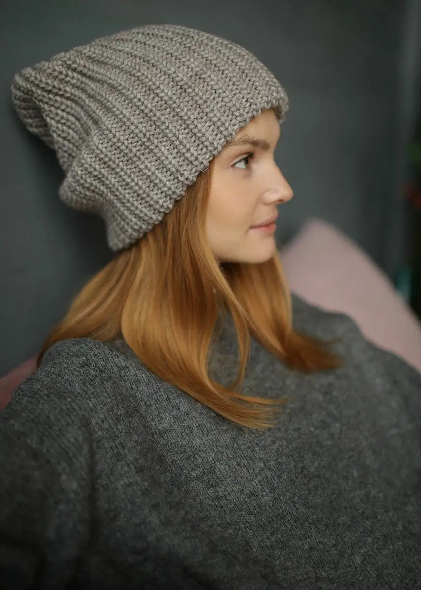 BRIKOLY London Gray & Beige knit beanie shown in profile on a model in a gray sweater.