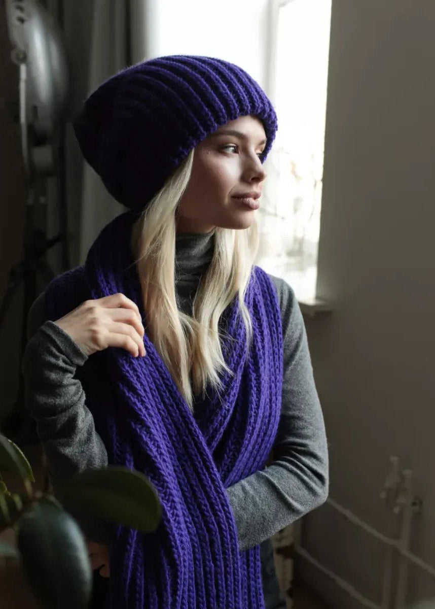BRIKOLY London Lavender knit beanie shown by a window with a matching scarf.