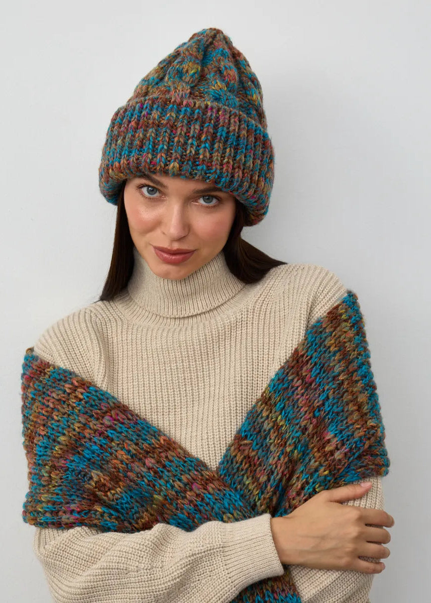 Tokyo Turquoise cable knit wool beanie: Outfit view with matching scarf held across the shoulders, sold separately