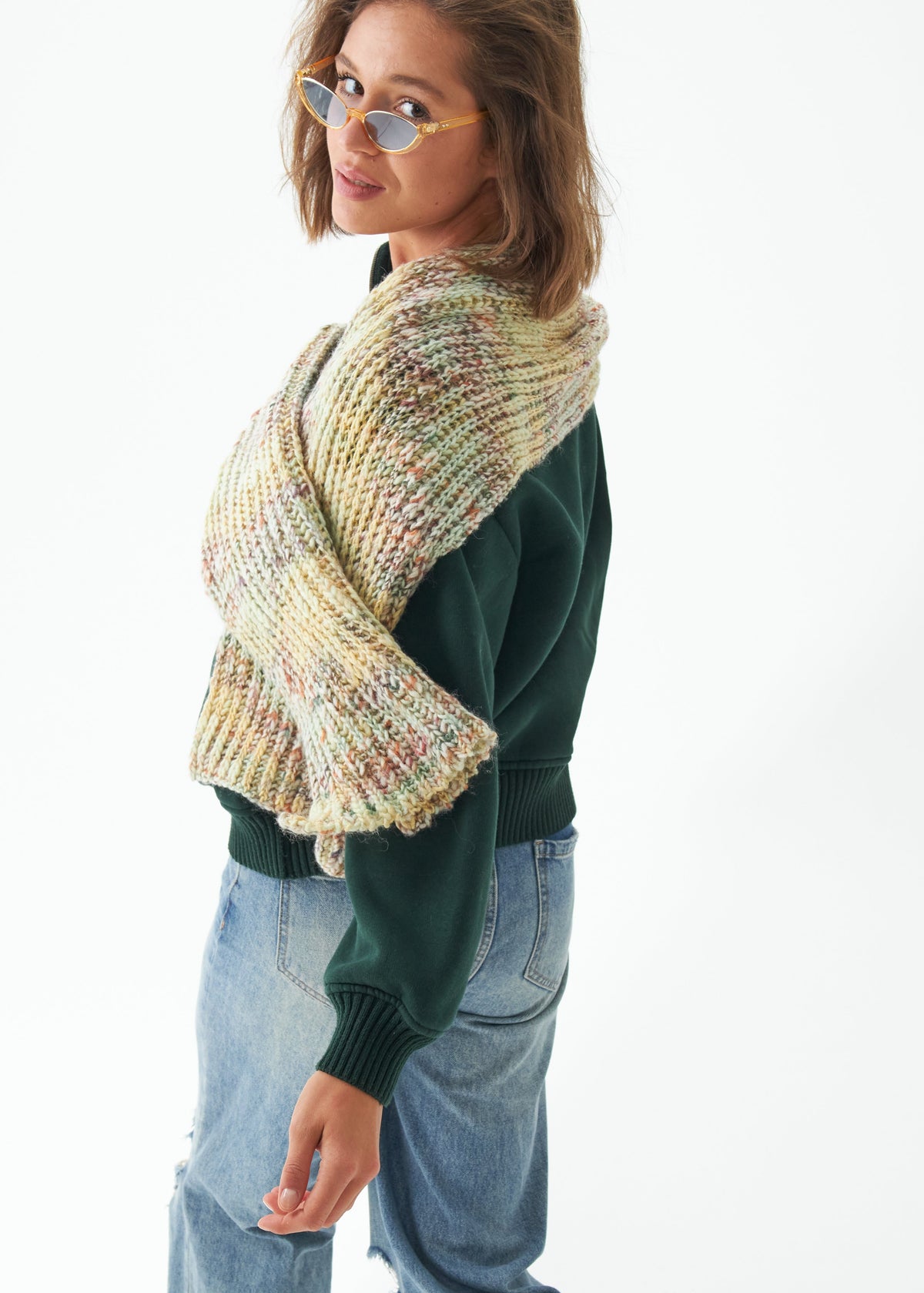 Oversized Yellow & Green alpaca-wool scarf: Side outfit view with one end over the shoulder; beanie sold separately