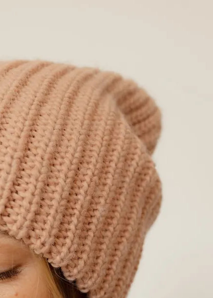 BRIKOLY London Peach knit beanie shown in a detail view of the knit brim.