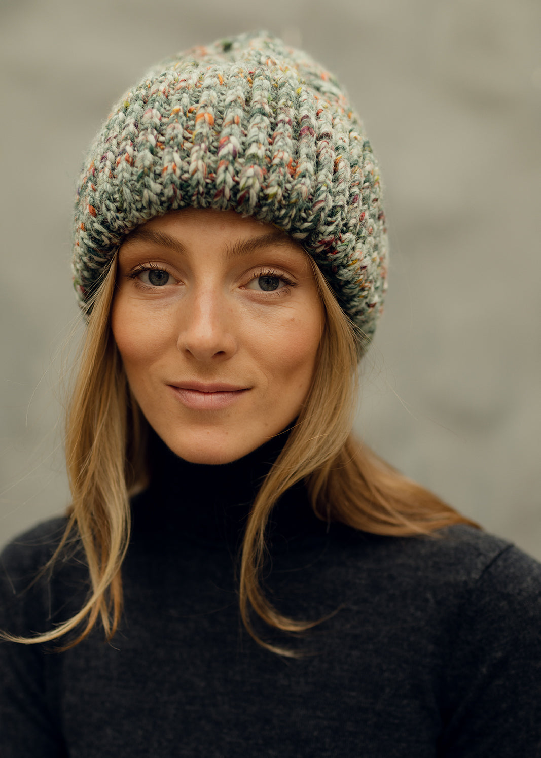 Tokyo Green cable knit wool beanie: Front portrait showing the folded cuff