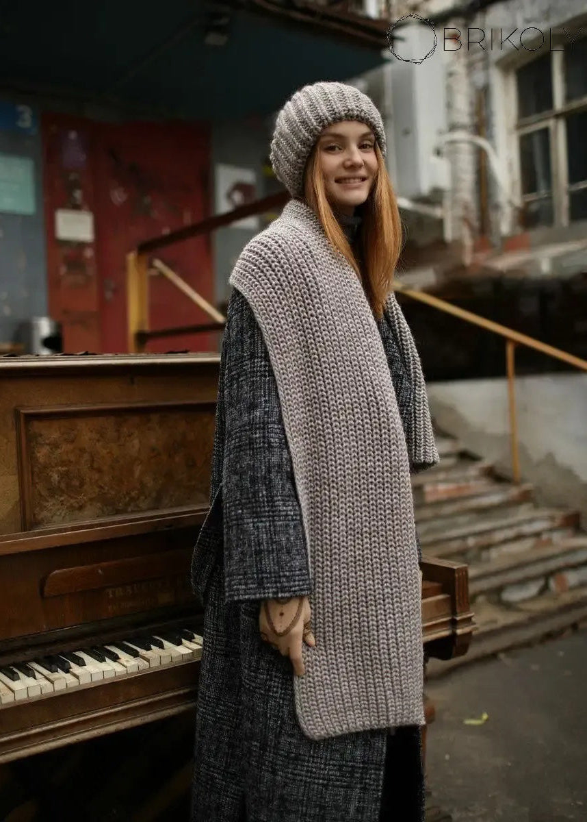 BRIKOLY London Gray & Beige knit beanie styled with a matching scarf outdoors.