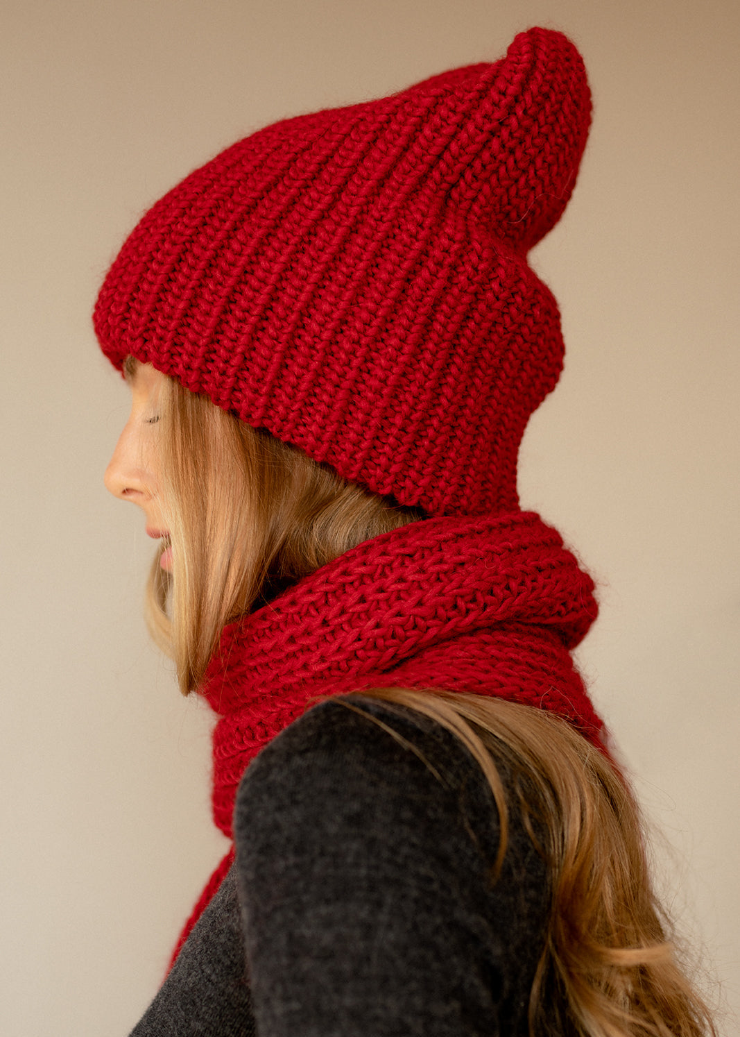 BRIKOLY London Burgundy knit beanie shown in profile with a matching scarf.