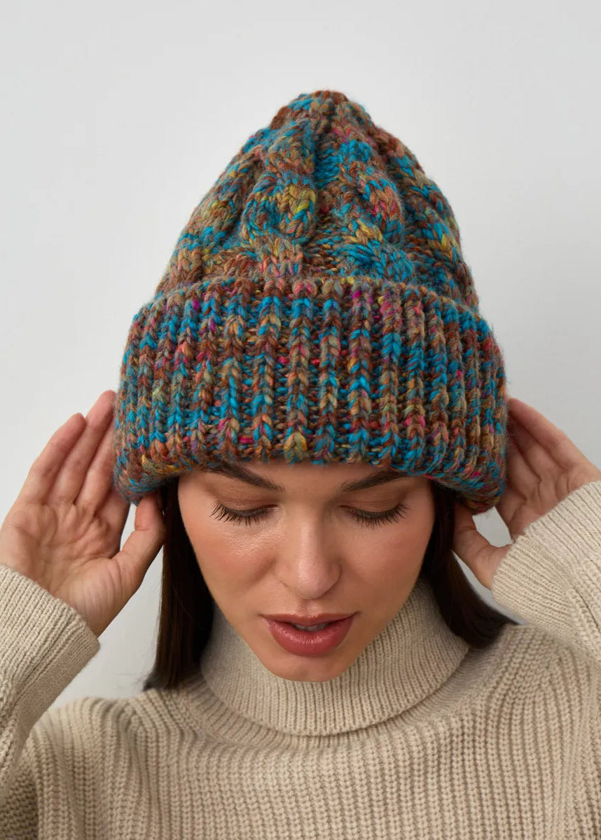 Tokyo Turquoise cable knit wool beanie: Front view with hands at the cuff