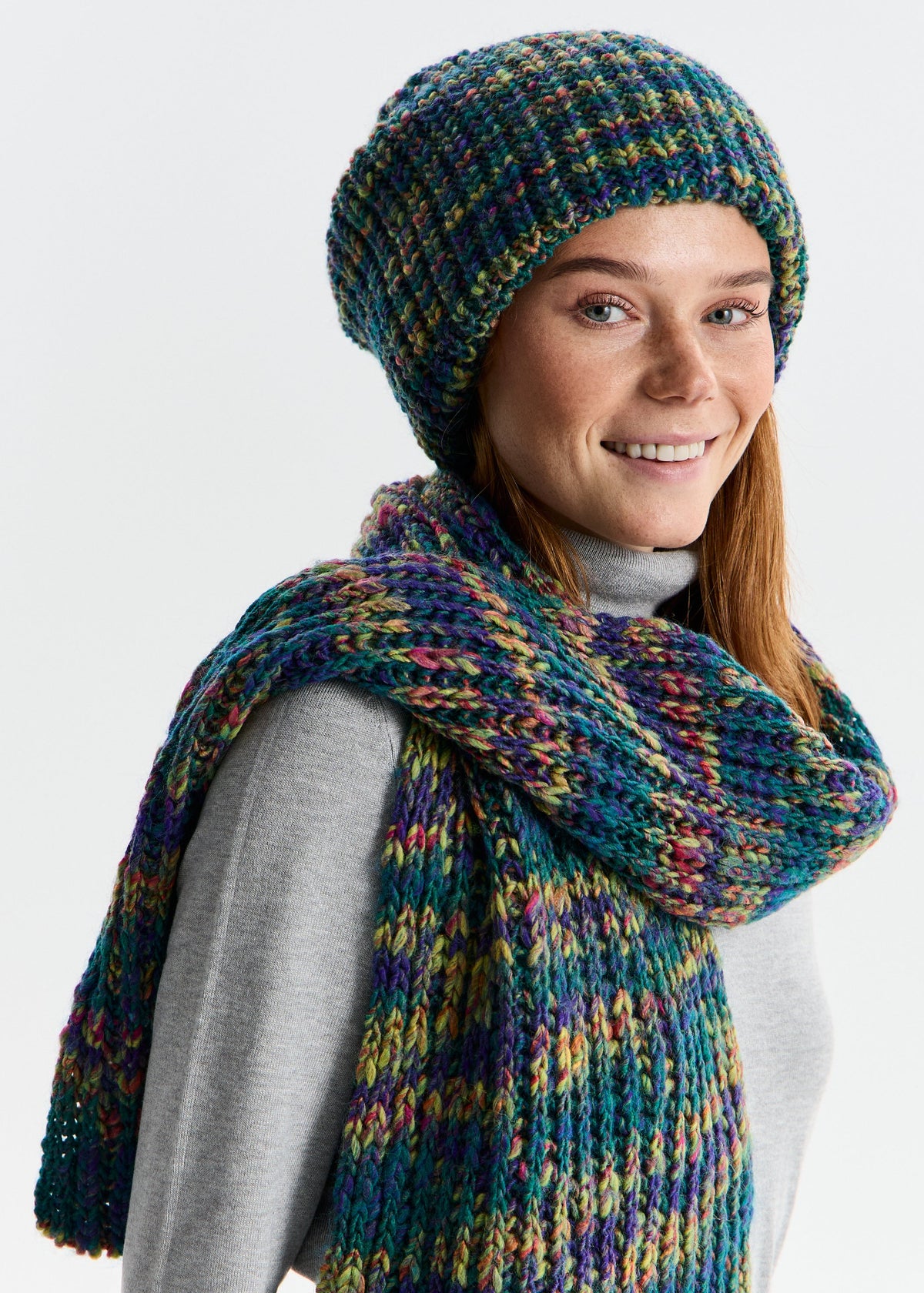 BRIKOLY London Lilac & Navy knit beanie worn by a smiling model with a matching scarf.