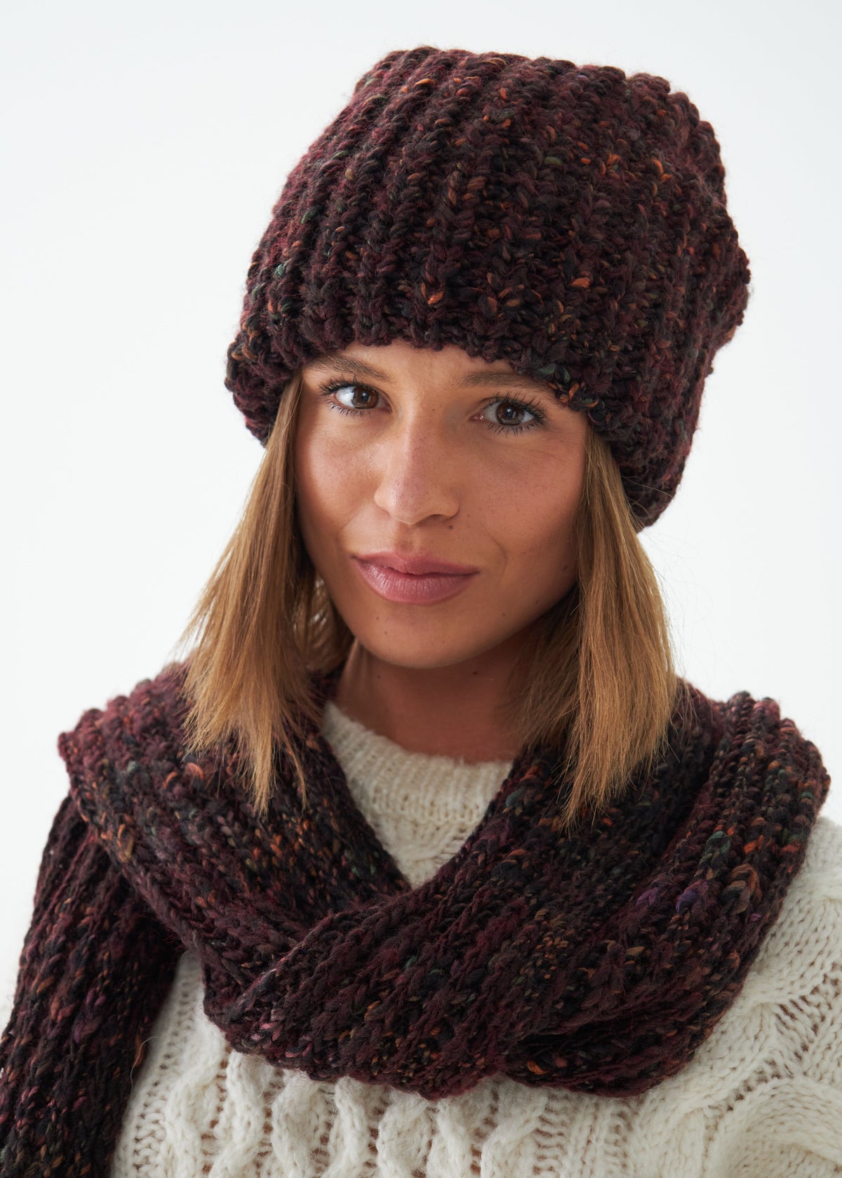 Oversized Maroon & Black alpaca-wool scarf: Front close-up wrapped at the neck; beanie sold separately
