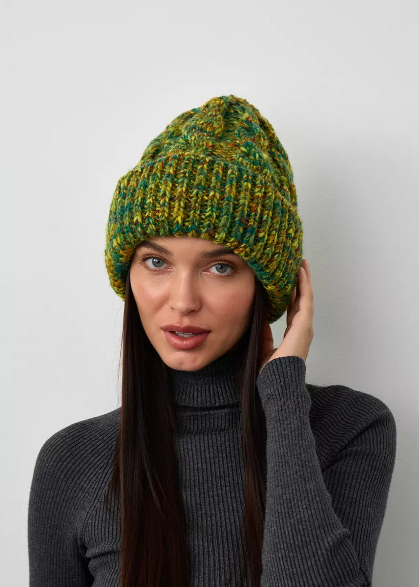 Tokyo Khaki cable knit wool beanie: Front close-up with a hand beside the face