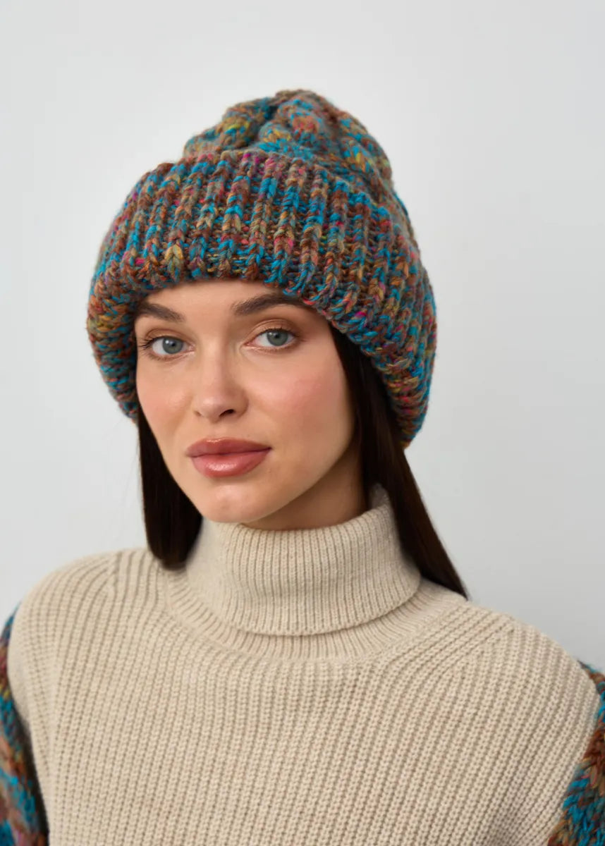 Tokyo Turquoise cable knit wool beanie: Three-quarter portrait with folded cuff