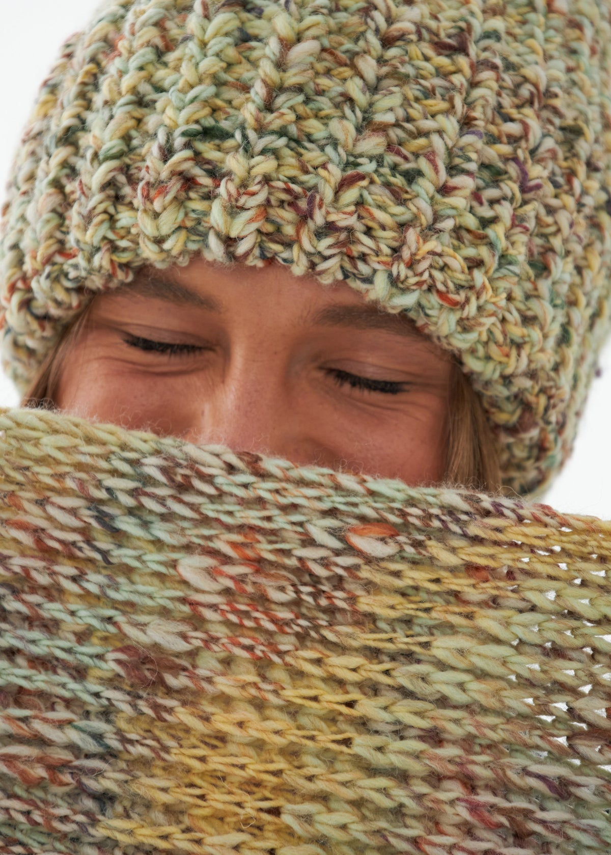 Oversized Yellow & Green alpaca-wool scarf: Close-up with scarf held near the face; beanie sold separately